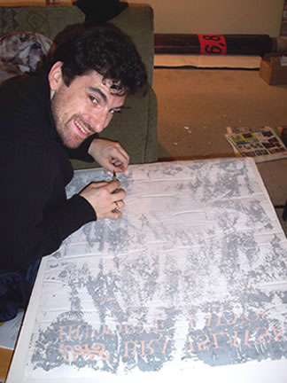 Golub hard at work, peeling off layers of excess paper from the back of a rare poster.
